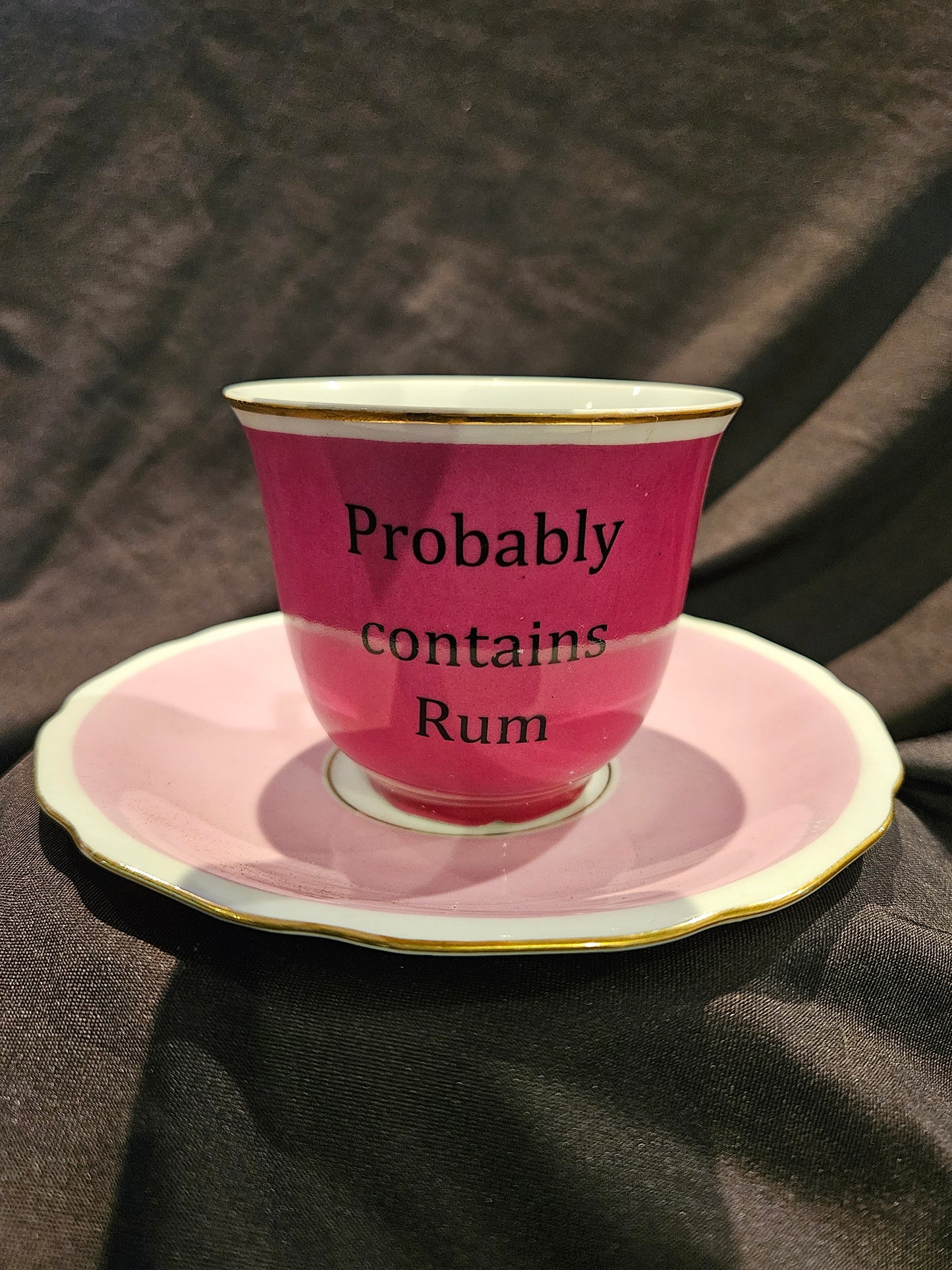 Probably contains Rum Teacup and Saucer