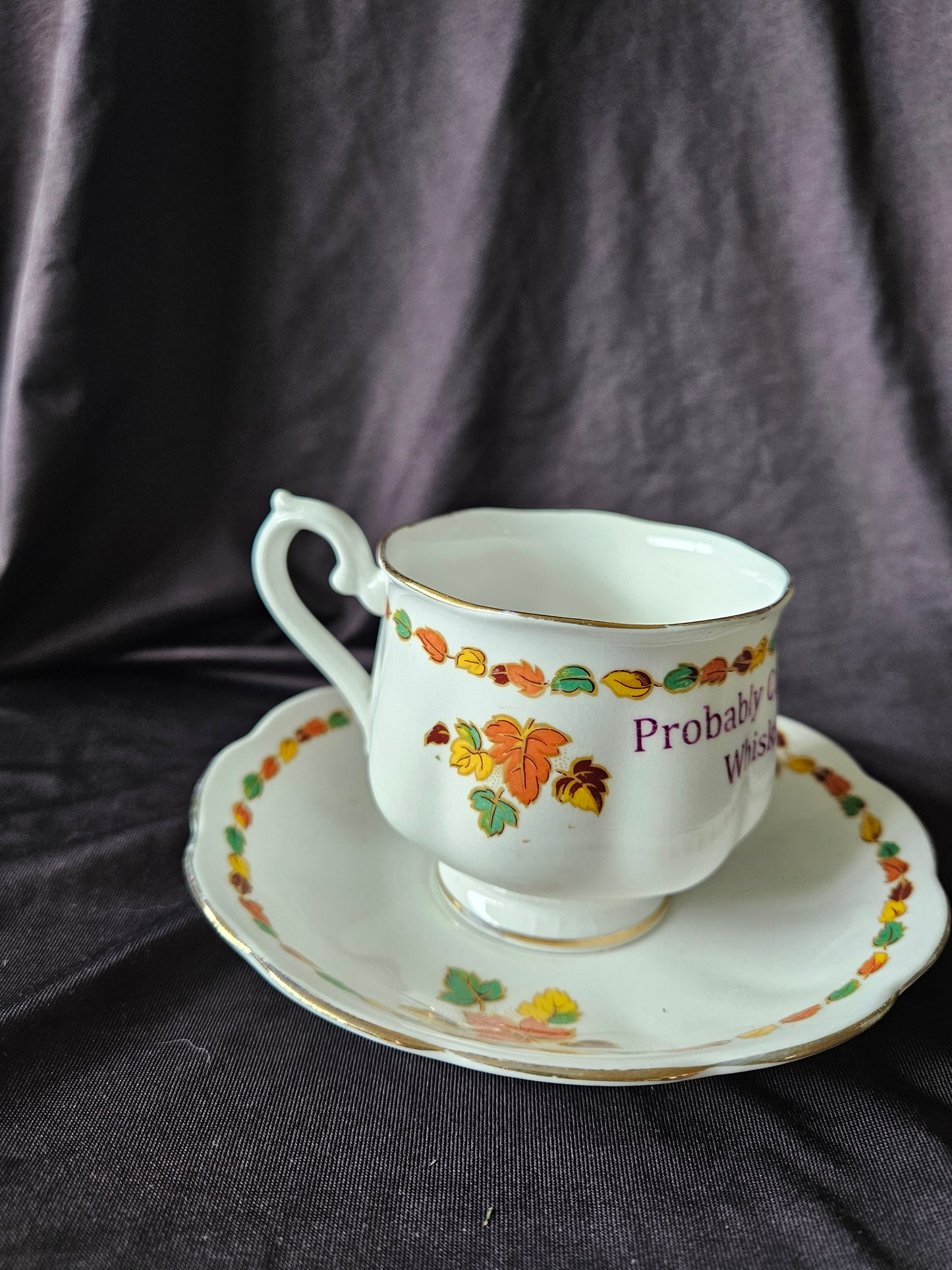 Probably contains Whiskey teacup and saucer