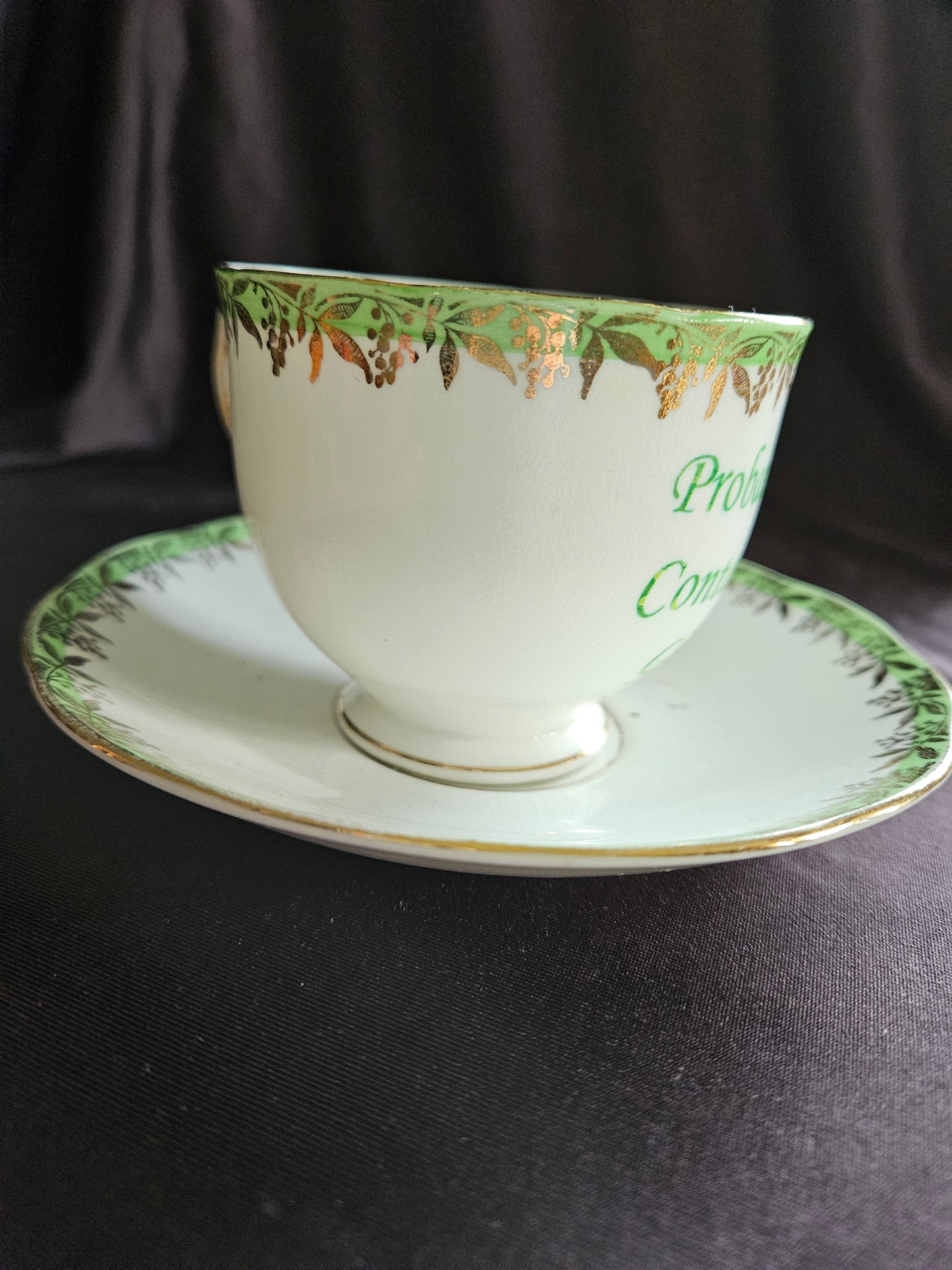 Probably contains Gin teacup and saucer