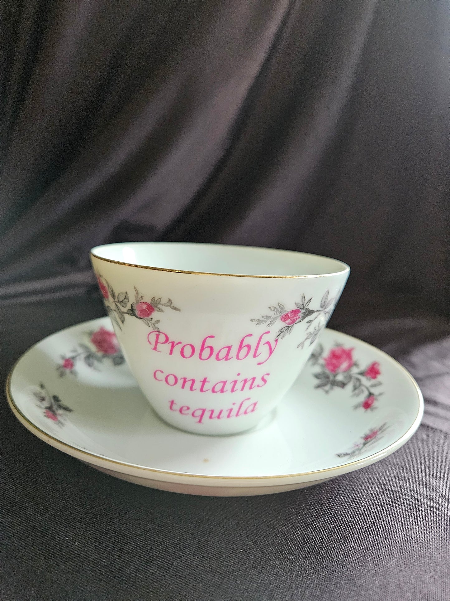 Probably contains Tequila teacup and saucer