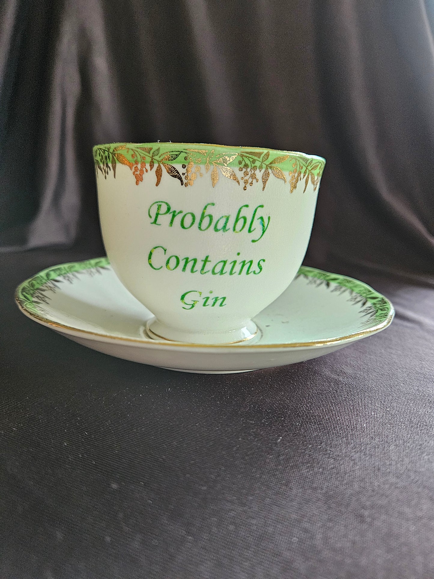 Probably contains Gin teacup and saucer