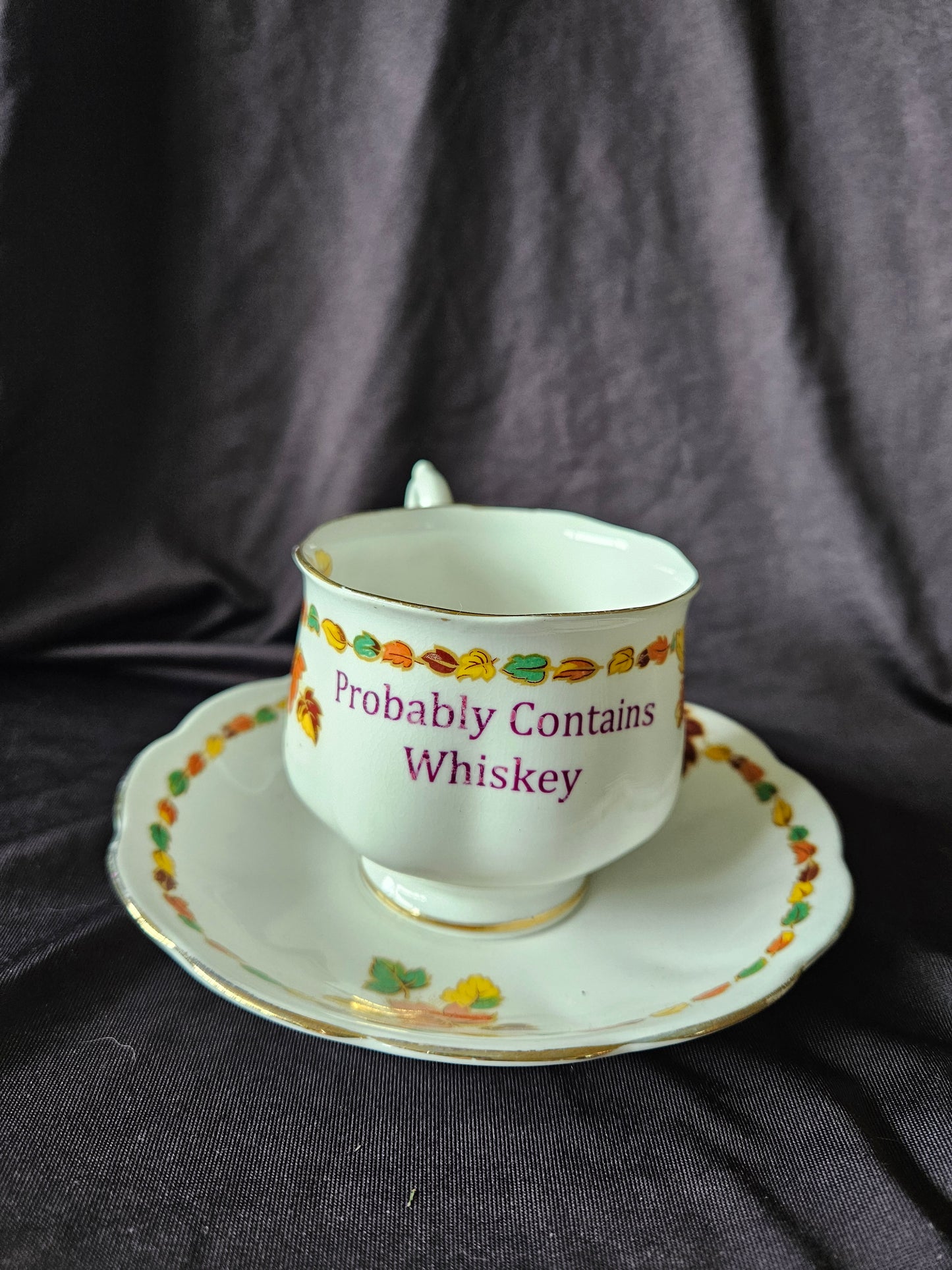 Probably contains Whiskey teacup and saucer